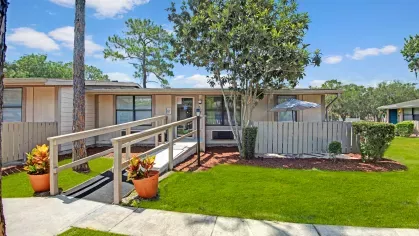 A wider view of the accessible ramp and surrounding apartments with landscaped yards.