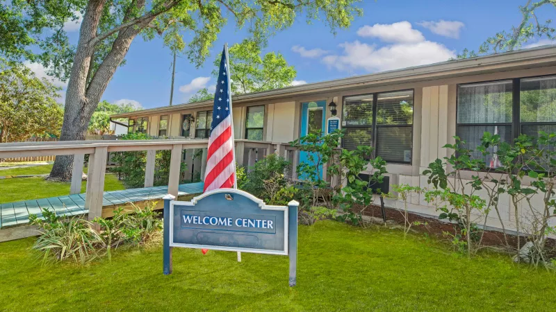 Another angle of the "Welcome Center" building, highlighting the ramp and vibrant outdoor surroundings.