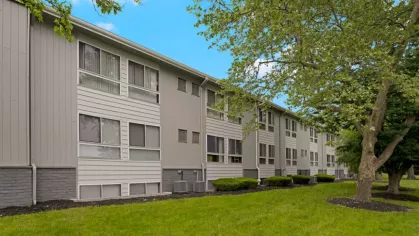 Exterior view of Rosehill Plaza apartments with well-maintained landscaping.