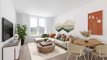 Bright and modern living room with a cozy sectional sofa, abstract wall art, and expansive windows.