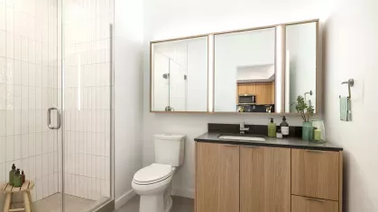 Contemporary bathroom with a glass-enclosed walk-in shower, illuminated mirrors, and a wood-accented vanity.