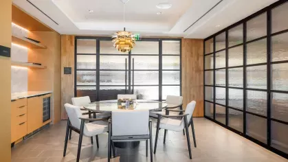 A sophisticated lobby at The Edmund Apartments showcasing a modern reception desk, artistic decor, and comfortable seating, creating a welcoming atmosphere.