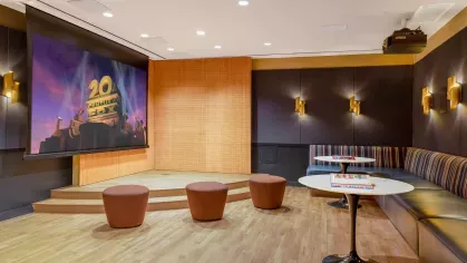 A cozy media room with a large projection screen, plush seating, and contemporary lighting, perfect for private movie nights.