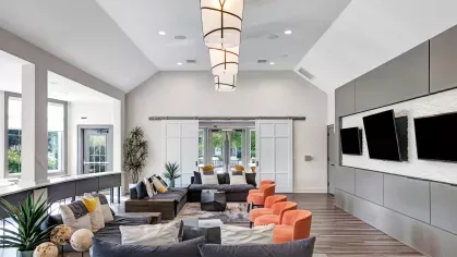 Lounge area with contemporary decor, flat-screen TVs, and ample seating options for residents.