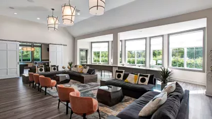 Stylish communal area with natural light, modern furnishings, and a dedicated workspace.