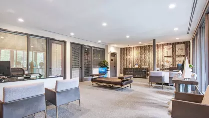 Welcoming leasing office interior at The Grove Somerset Apartments, featuring contemporary decor and a comfortable seating area.