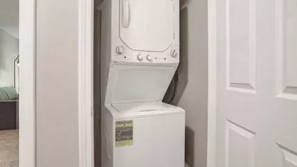 A compact laundry area with an energy-efficient stackable washer and dryer.