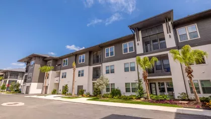 "Street view of Tropia Wellen Park Apartments showcasing the contemporary architectural design."