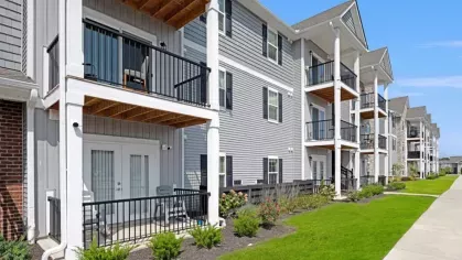 Well-maintained apartment buildings with private patios and balconies, offering a welcoming atmosphere.