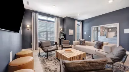 A relaxing lounge with plush seating, elegant decor, and large windows bringing in natural light.