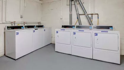 On-site laundry room with modern washers and dryers at Washington Gardens Apartments in Washington, NJ, offering convenience for residents.