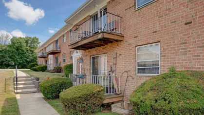 Cozy private balconies and brick exterior at Washington Gardens Apartments, providing a charming and comfortable living space.