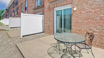 Outdoor patio space with privacy fencing and room for dining furniture, perfect for entertaining or relaxation.