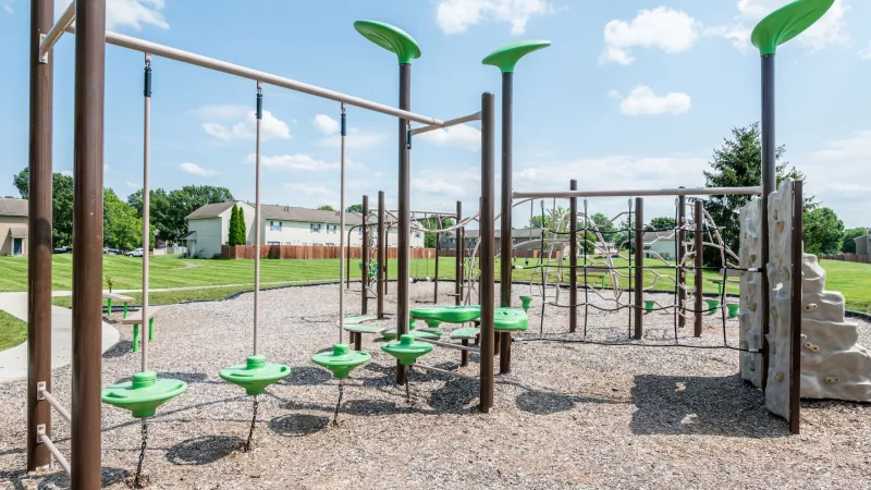 "Playground at Worthington Meadows Apartments with climbing structures, swings, and open grassy areas for children."