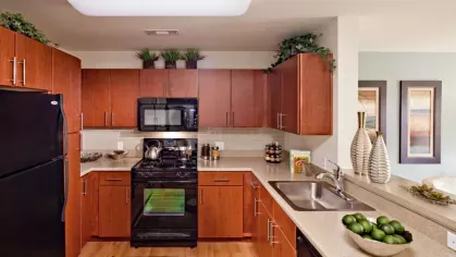 A bright and inviting kitchen with a breakfast bar, white cabinetry, and modern appliances, seamlessly flowing into the dining area.