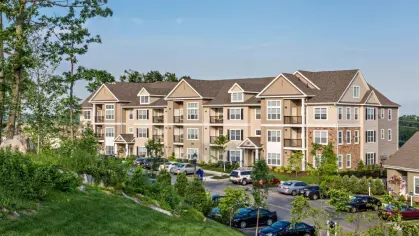 Elevated view of Vista At Town Green’s apartment community, surrounded by greenery with ample parking and beautifully maintained landscaping.