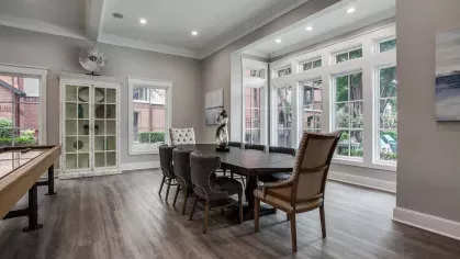 A well-appointed dining area with a long table and upholstered chairs, perfect for gatherings.