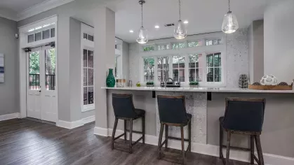 A sleek, fully equipped kitchen with stainless steel appliances and a modern backsplash.