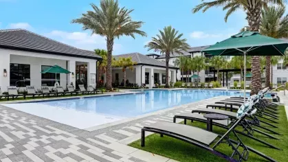 A picturesque pool area with comfortable lounge chairs and a tropical resort-style ambiance.