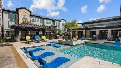 A luxurious poolside with chaise loungers, cabanas, and vibrant landscaping, perfect for relaxation.