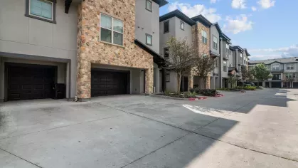 Private, attached garages with stone-accented exteriors and ample driveway space in the community.