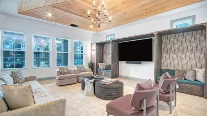 Luxury lounge space with designer furniture, rich wood paneling, and vibrant decor for an upscale ambiance.