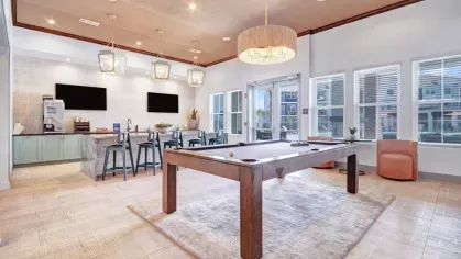 Luxury lounge space with designer furniture, rich wood paneling, and vibrant decor for an upscale ambiance.