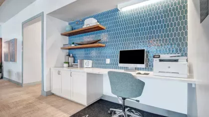 Luxury lounge space with designer furniture, rich wood paneling, and vibrant decor for an upscale ambiance.