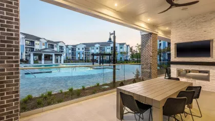 Expansive clubhouse with high-end furnishings, featuring a modern co-working space and stylish decor.