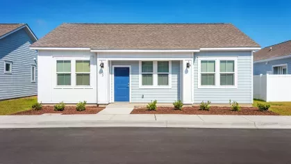 Street-facing view of Artisan Carolina Forest with well-maintained grounds, outdoor balconies, and convenient parking, emphasizing the charm and accessibility of the community.