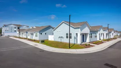 Street-facing view of Artisan Carolina Forest with well-maintained grounds, outdoor balconies, and convenient parking, emphasizing the charm and accessibility of the community.