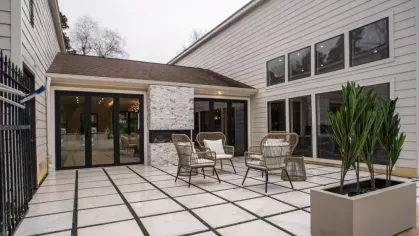 An inviting outdoor patio with stylish seating and a modern fireplace at Aurella Cary Apartments