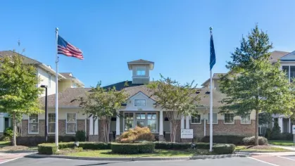 A compact gym with modern exercise equipment, including treadmills and weightlifting machines.