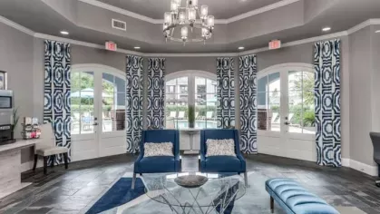Chic and welcoming clubhouse with blue accents and contemporary decor at The Landings of Conroe Luxury Apartments.