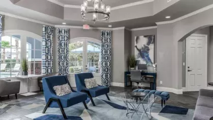Stylish clubhouse lounge with comfortable seating and workspaces at The Landings of Conroe Luxury Apartments.