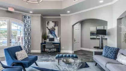 Sophisticated seating area in the clubhouse, featuring blue and gray modern decor at The Landings of Conroe Luxury Apartments.