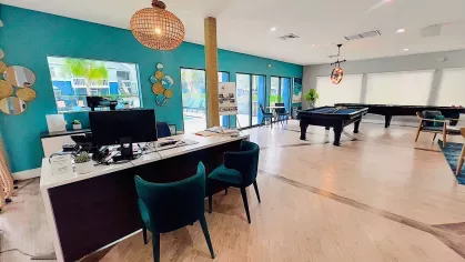 Cozy lounge area with teal sofas, vibrant decor, and a striking octopus mural on the wall, offering a unique and stylish spot for relaxation.