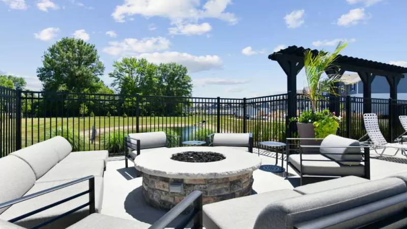 An outdoor fire pit lounge with comfortable seating and scenic views at Lawndale Commons, perfect for socializing and relaxation.