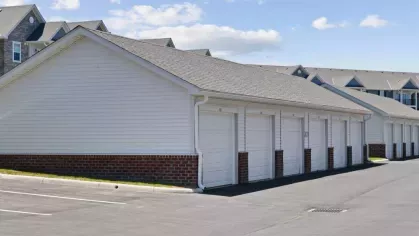 Additional detached garages at Lawndale Commons, providing ample parking space for residents with a clean, well-paved lot.