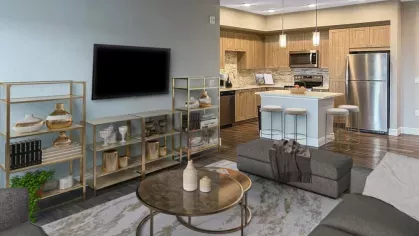 A bright and airy apartment showcasing a refined color palette, contemporary furniture, and a seamless transition between living and dining areas.