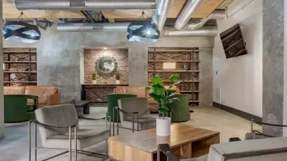 Stylish lounge area with contemporary seating, exposed brick, and industrial lighting.