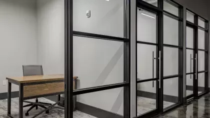 Quiet private office space with modern glass partitions and polished concrete floors.