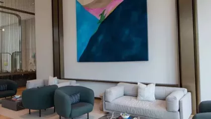 A chic lounge with cozy seating arrangements, contemporary art, and a polished black marble coffee table.