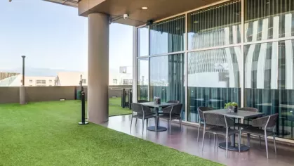 Spacious terrace with outdoor seating and artificial grass flooring.