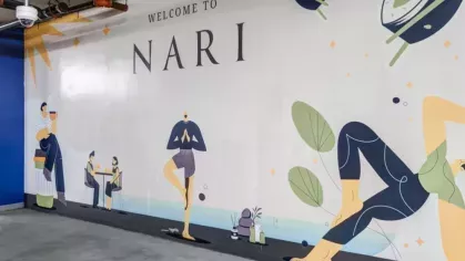 Colorful mural with 'Welcome to Nari' text featuring playful illustrations of people practicing yoga and dining outdoors on a concrete wall.