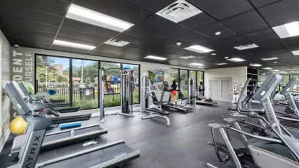 The Oak Enclave gym offers high-quality treadmills, weight stations, and resistance training equipment in a sleek, modern setting.
