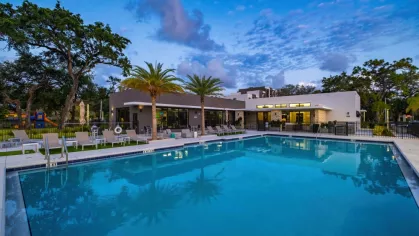 A beautifully lit pool reflecting the night sky, creating a tranquil and elegant setting for residents of Oak Enclave Luxury Apartments.