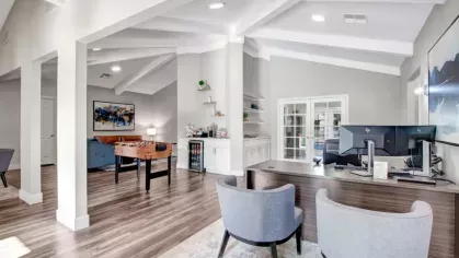 Leasing office with a foosball table, comfortable seating, and a bright, welcoming design.