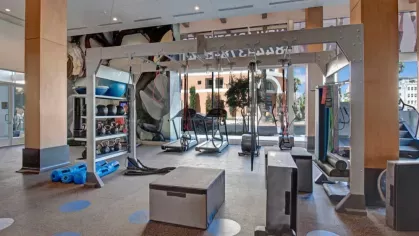 Functional training area with suspension equipment, kettlebells, and open space for workouts.