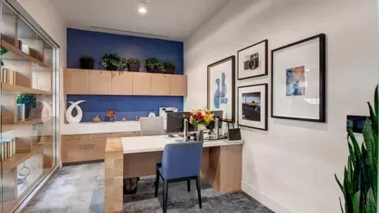 Stylish leasing office with a welcoming desk, vibrant wall art, and decorative accents.